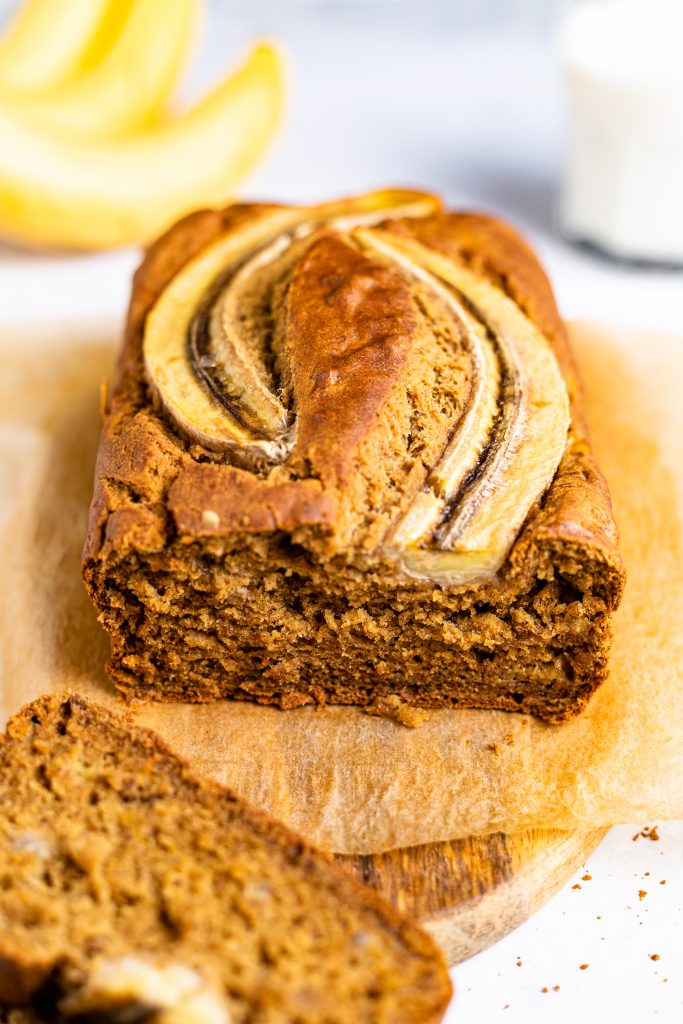 Gluten-free and dairy-free banana bread with a slice removed.