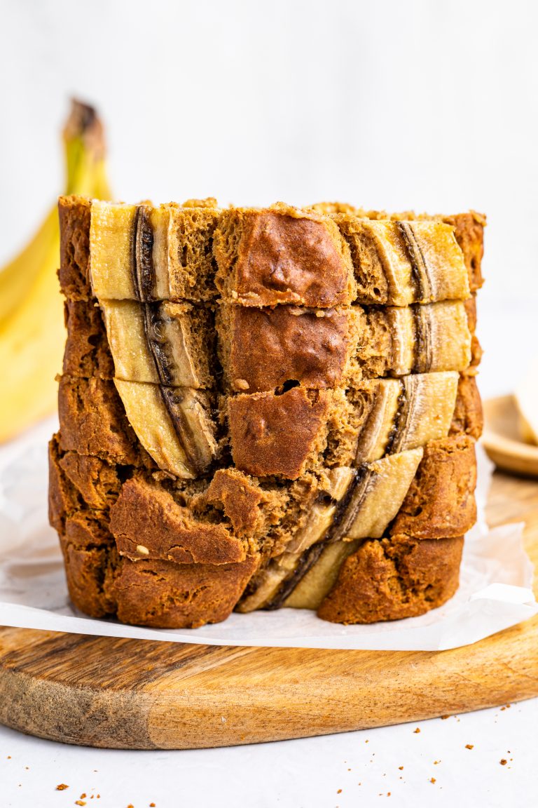 Slices of gluten-free and dairy-free banana bread stacked on top of each other.