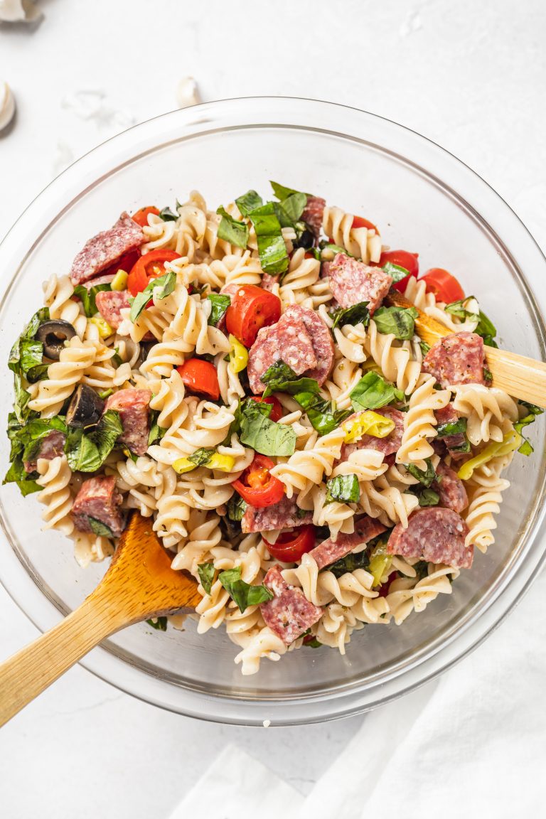 gluten-free pasta salad in a big bowl with a wooden spoon