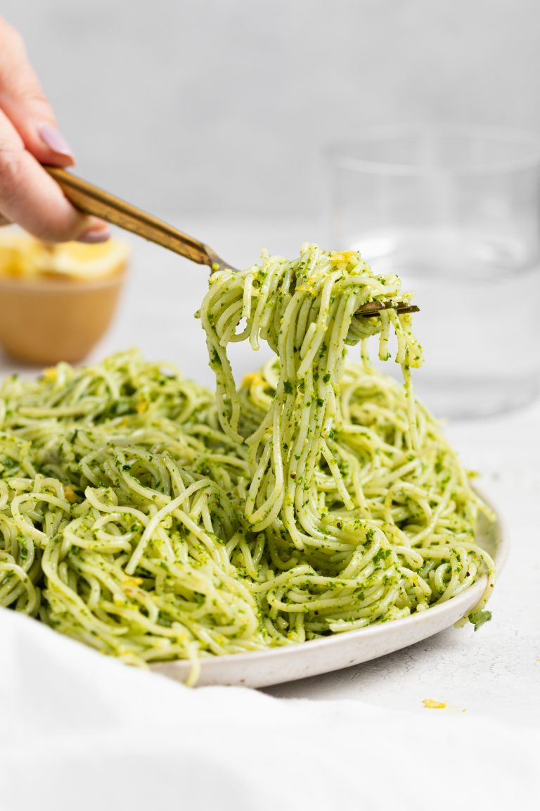 Kale pesto in spaghetti being twirled with a fork.