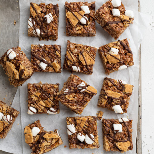 overhead image of s'mores rice crispy treats with milk and rice cereal on the side.