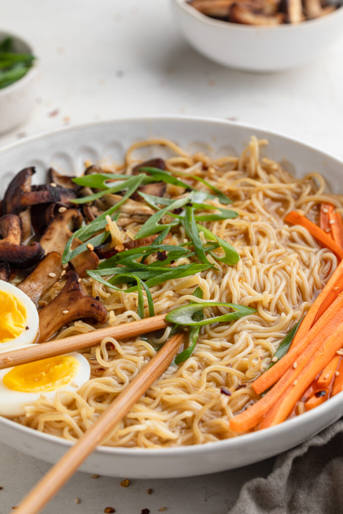 close-up image of spicy ramen with chopsticks