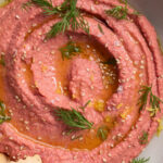 close-up image of beet hummus in a bowl.
