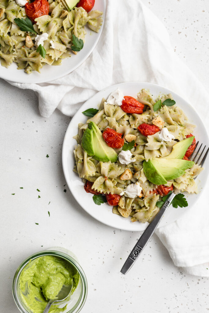 overhead image of avocado pasta on two plate