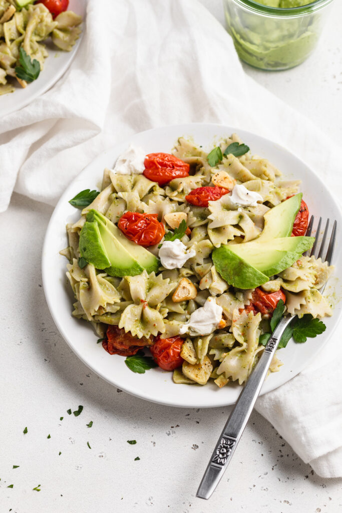 avocado pasta on a plate with a fork