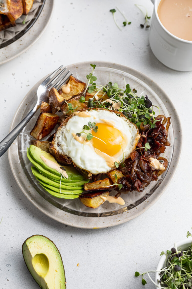 breakfast bowl with coffee and avocado on the side.