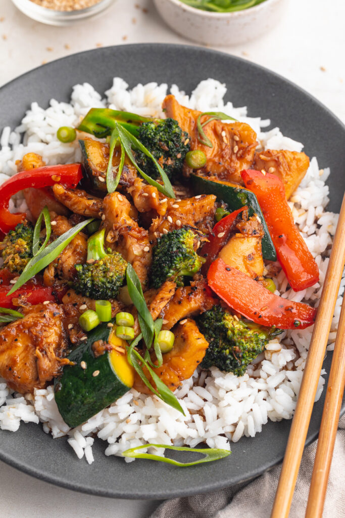 hunan chicken on a plate over rice.