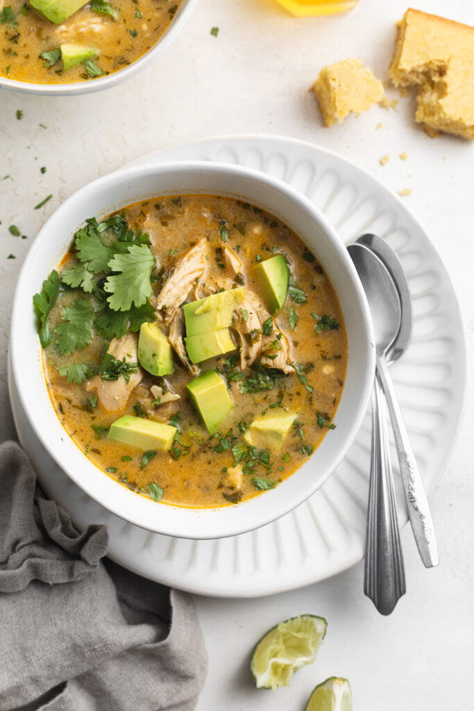overhead image of Instant Pot white chicken chili with cilantro and avocado on top