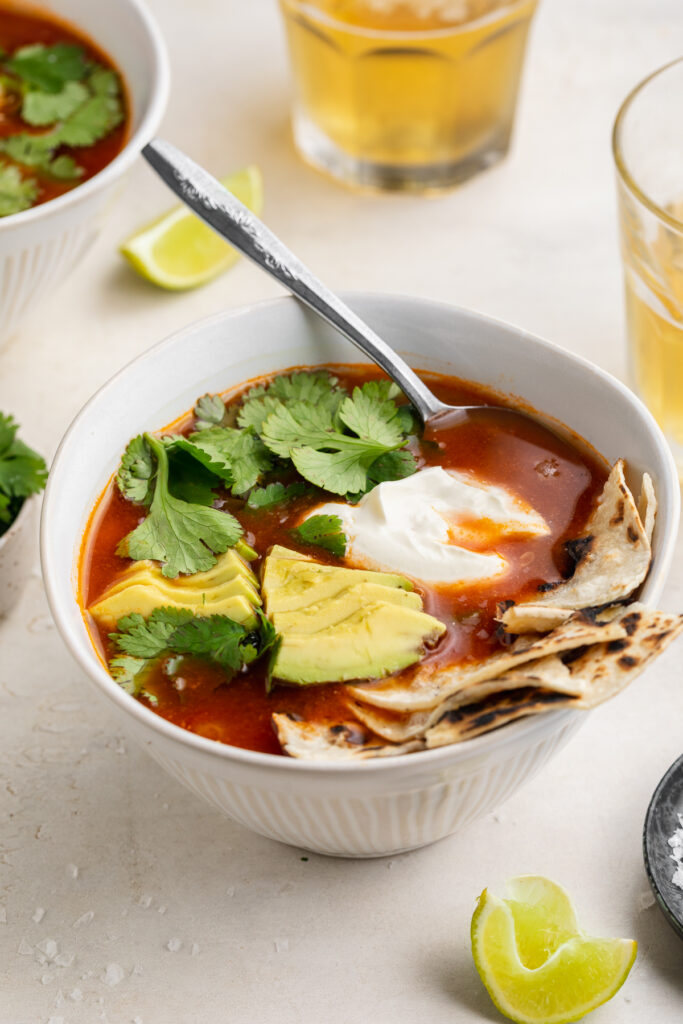 mexican chicken soup in a bowl with a spoon.