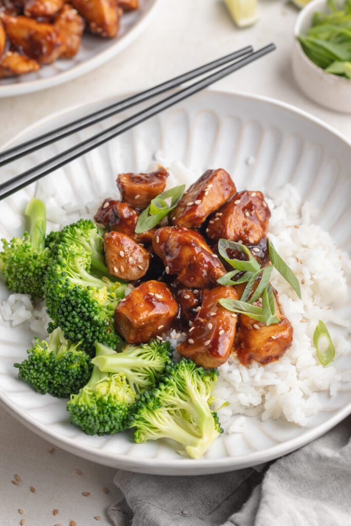 healthy teriyaki chicken rice bowls with sliced green onion on top.