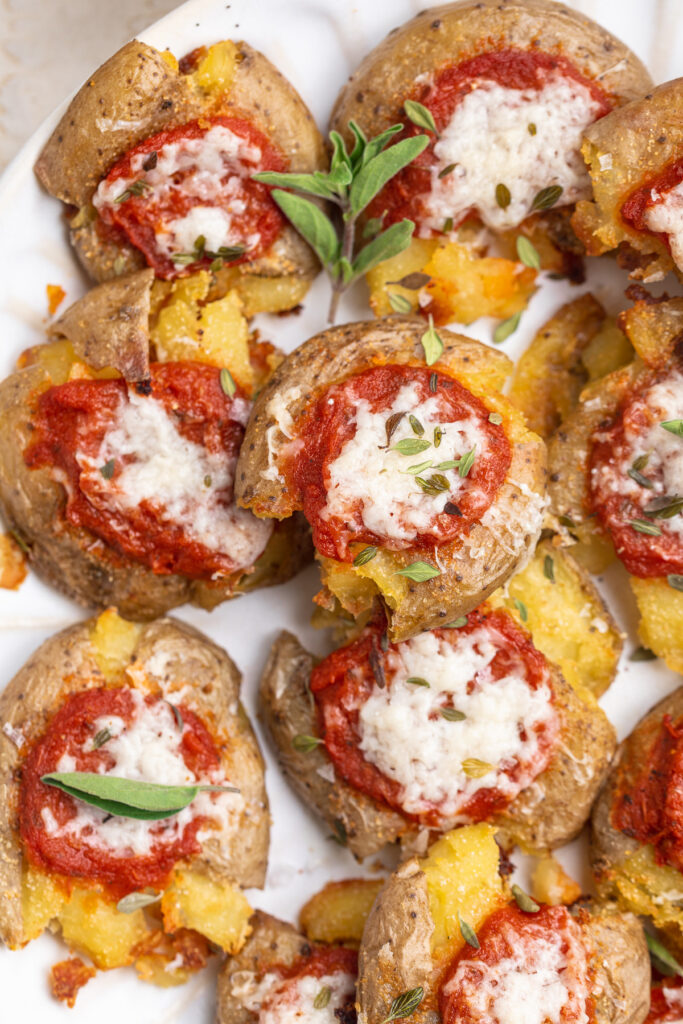 close-up overhead image of pizza smashed potatoes with oregano.