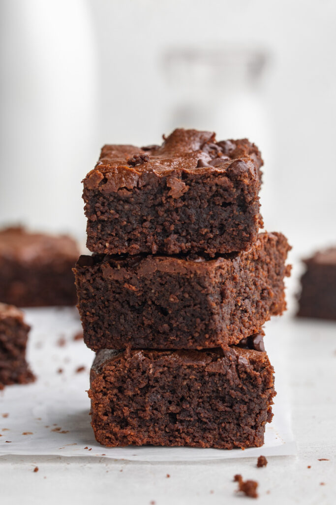 three almond flour brownies stacked on top of each other.