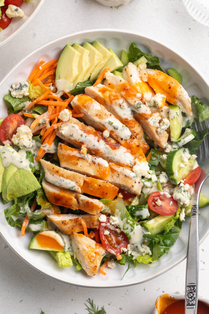 Close-up overhead image of buffalo chicken salad in a bowl.