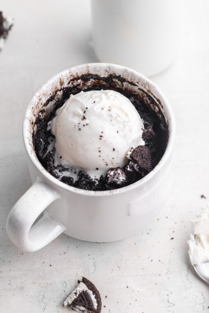 oreo mug cake with milk on the side.