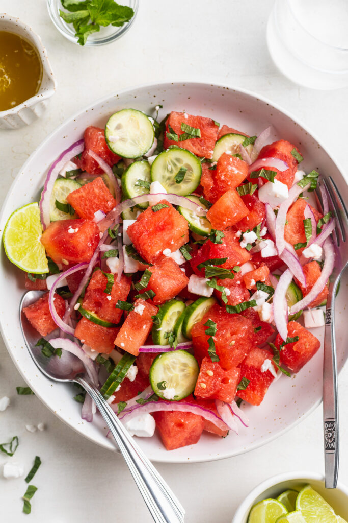 overhead image of watermelon salad in a bowl.