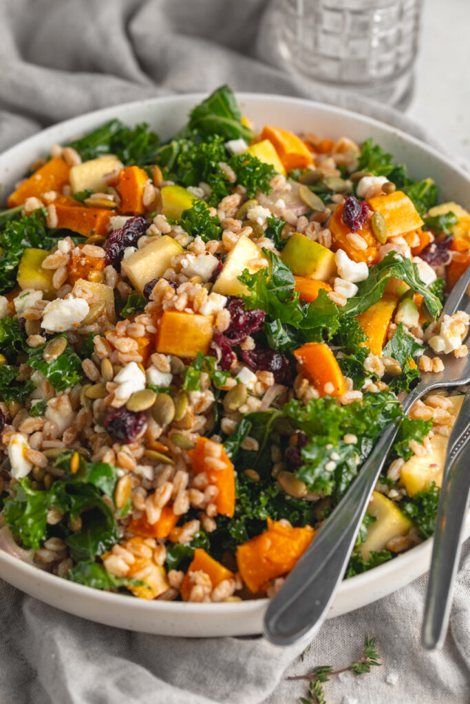 Thanksgiving salad in a bowl with a fork and spoon.