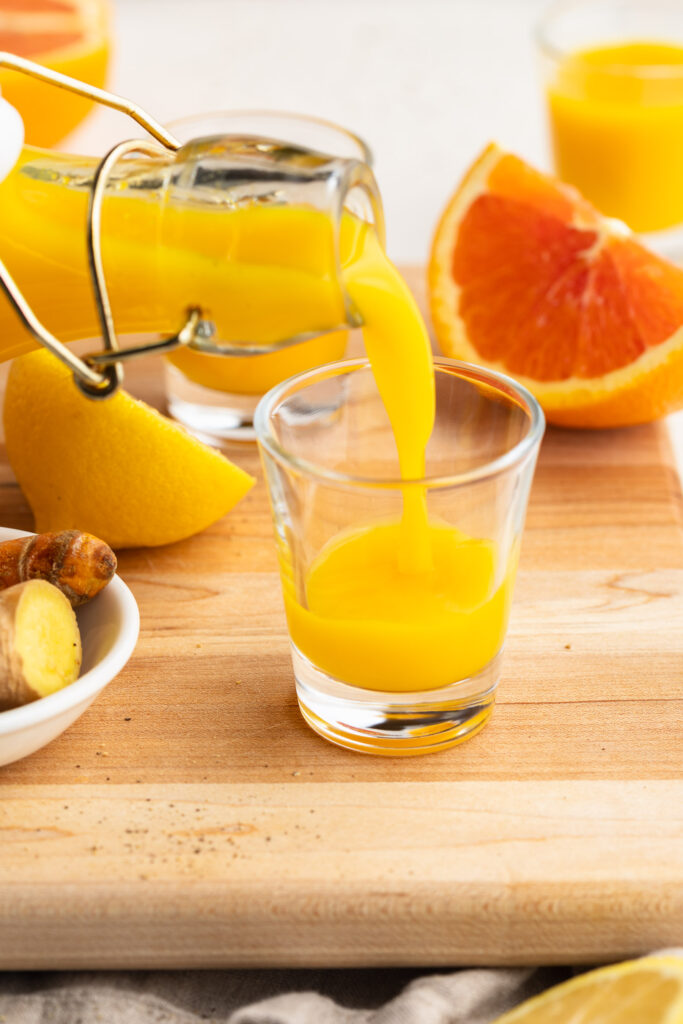 homemade immunity shot being poured into a glass.