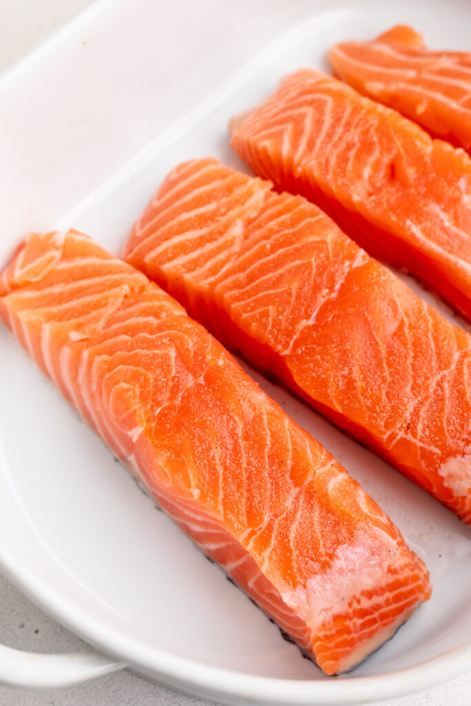 salmon fillets in a baking dish with salt on top