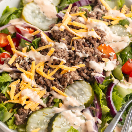 big mac salad in a bowl with sesame seeds on top.