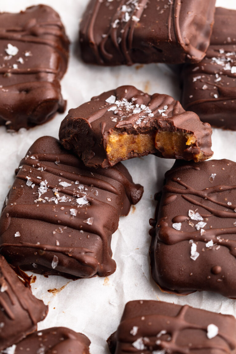 date caramels on a plate with flaky sea salt on top.