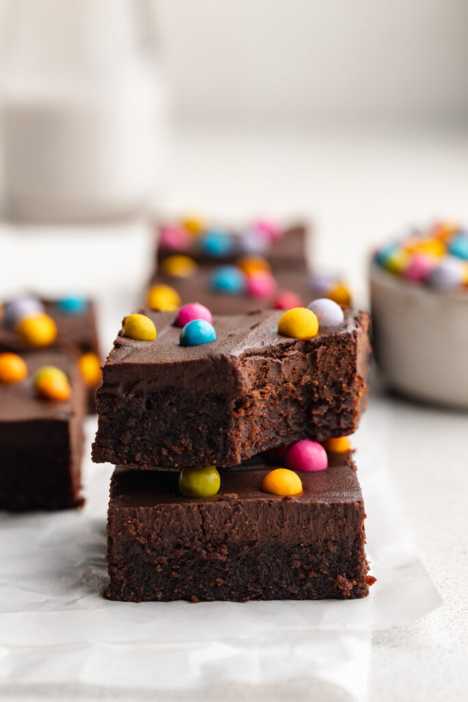 two healthy gluten free cosmic brownies stacked on top of each other.