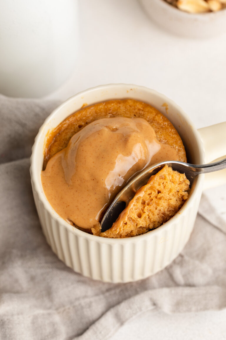 3 ingredient peanut butter mug cake with extra peanut butter on top.