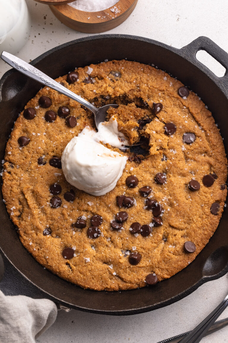 overhead image of healthy gluten-free cookie skillet with a scoop of vanilla ice cream on top.