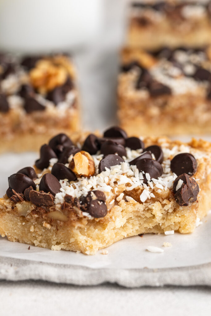 a healthy gluten-free magic bar with a bite taken out.