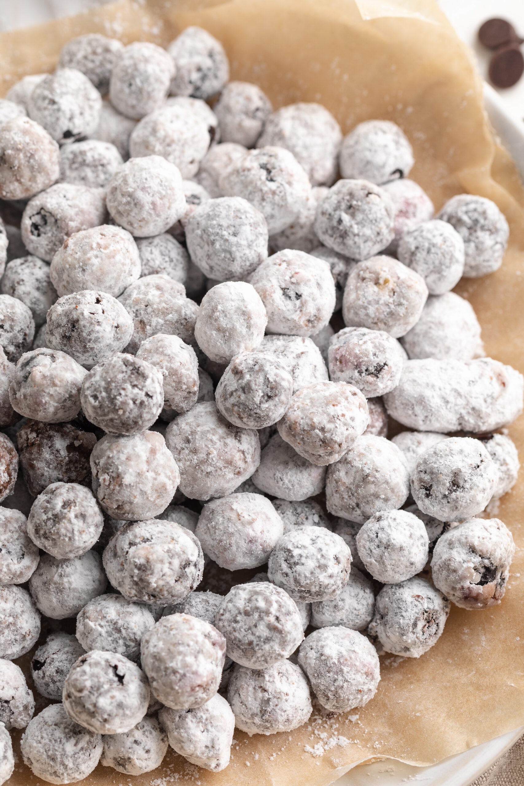 blueberry muddy buddies on a plate with chocolate chips on the side.