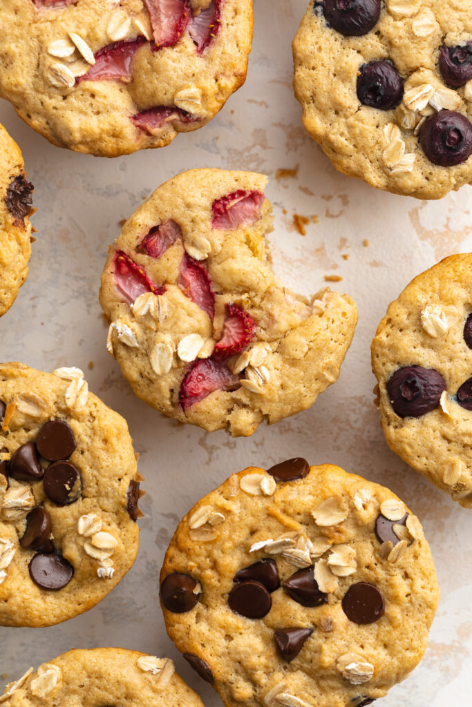 overhead image of healthy oat breakfast muffins with a bite taken out.