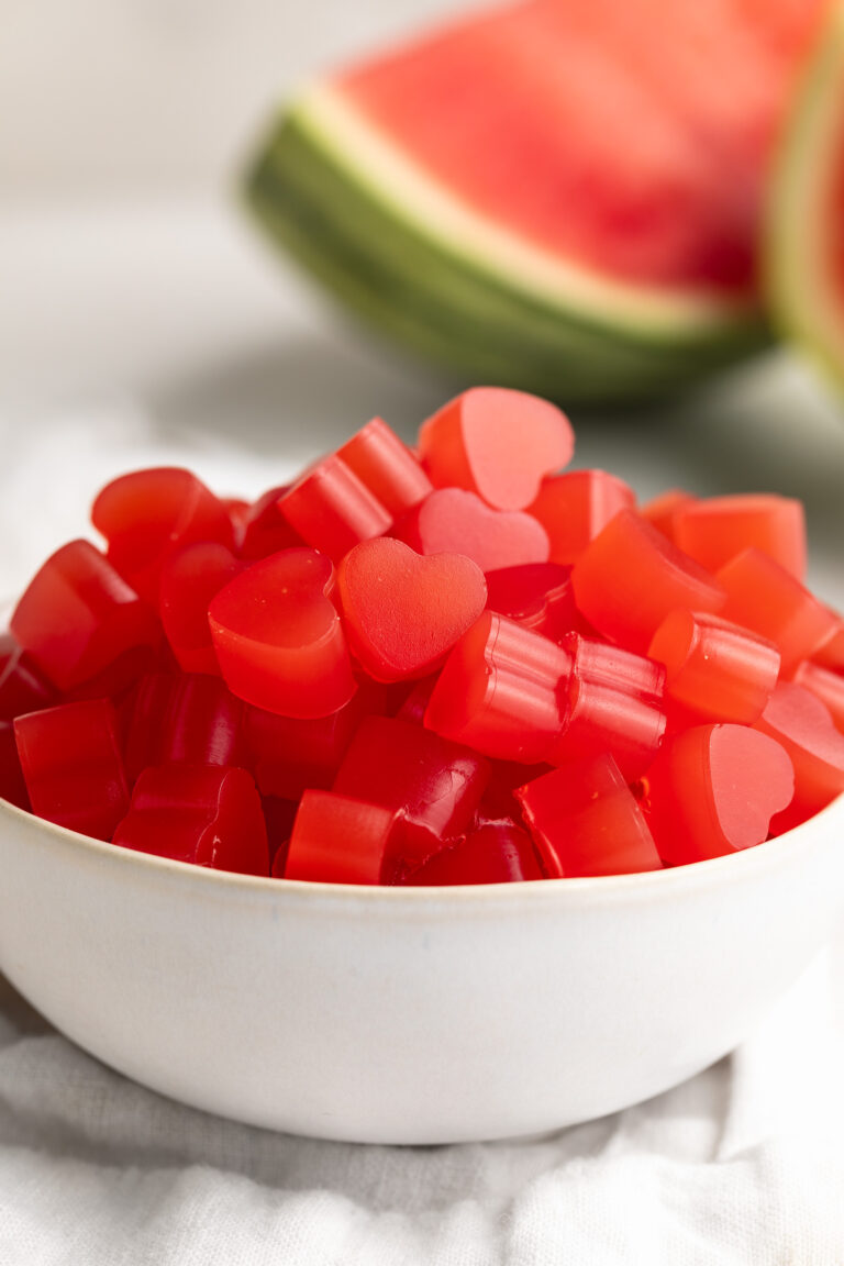 small bowl of 3 ingredient healthy watermelon gummies with fresh watermelon on the side.
