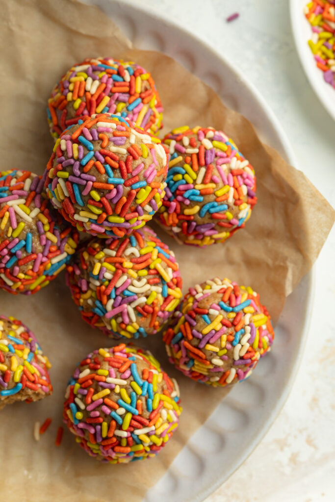 overhead image of birthday cake energy bites on a plate.