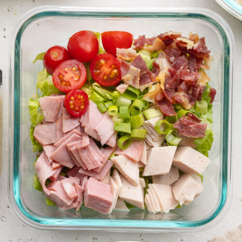 overhead image of a meal prep turkey club chopped salad.