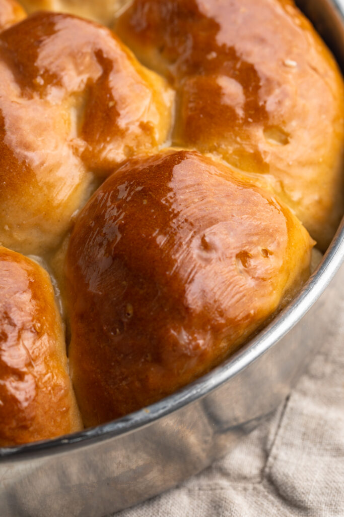 close up image of gluten-free dinner rolls in a baking dish.