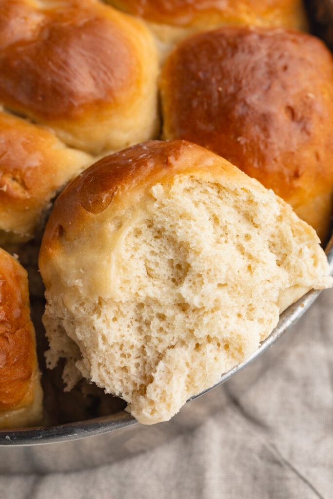 The inside of a gluten-free dinner roll in a pan.