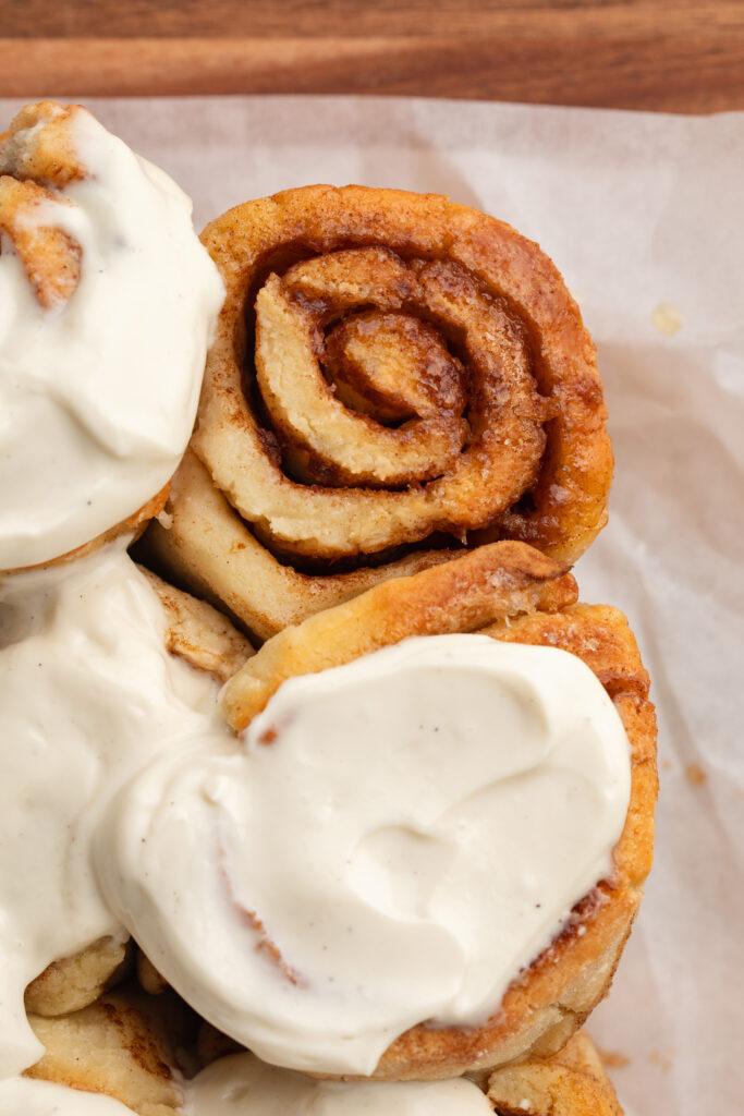 overhead image of protein cinnamon rolls with greek yogurt frosting on top.