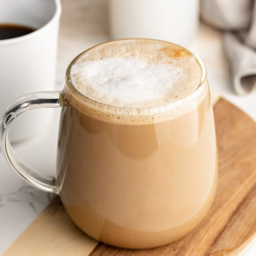 protein coffee on a table with coffee and milk on the side.