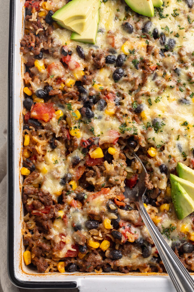 close up image of a spoon in burrito bowl casserole.