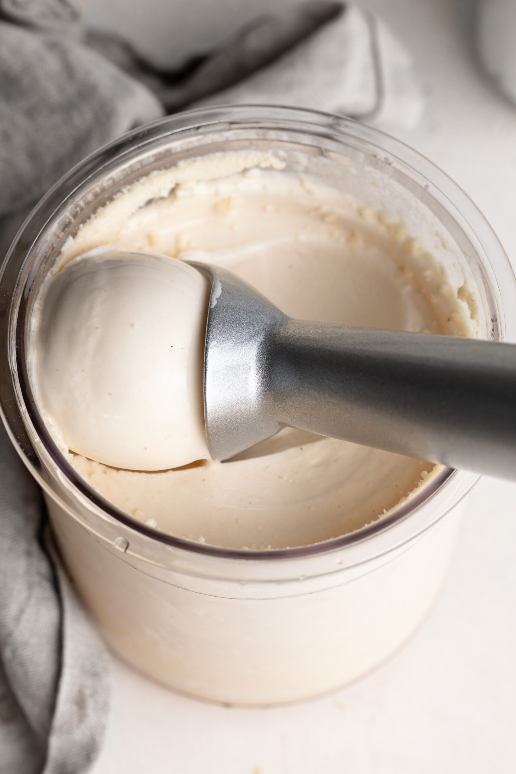 2 ingredient protein ice cream in a ninja creami cup with an ice cream scoop.