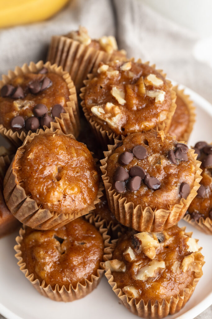 mini banana muffins piled on a plate.