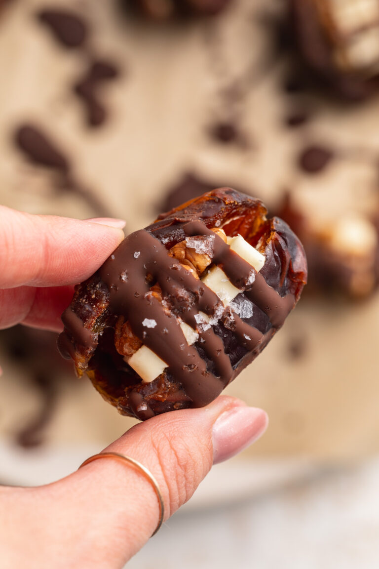 hand holding a butter pecan stuffed date.