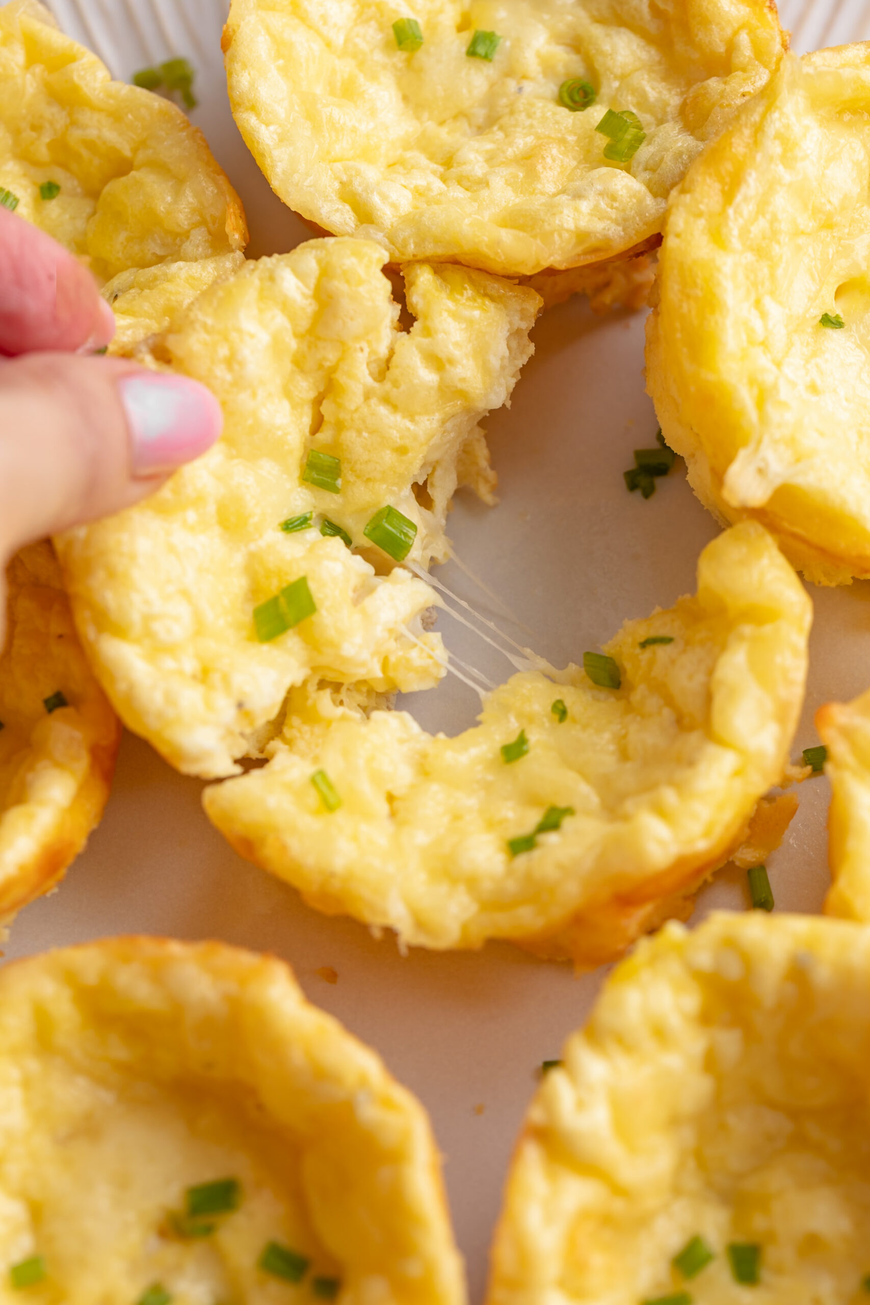 Pulling apart a cheesy cottage cheese egg bite.